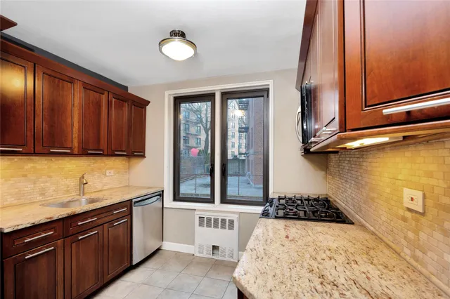 a kitchen with sink cabinets and window