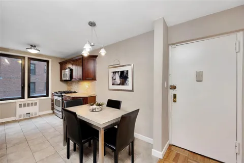 a view of a dining room with furniture and window