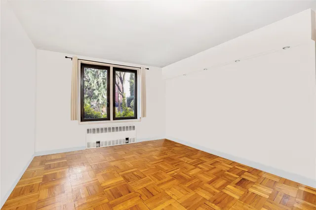 a view of a bedroom with a bed and a window