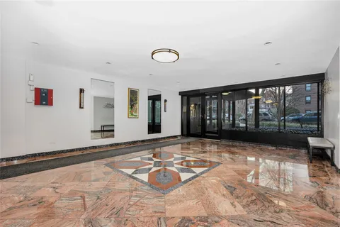 a view of a livingroom with an empty space and floor to ceiling window