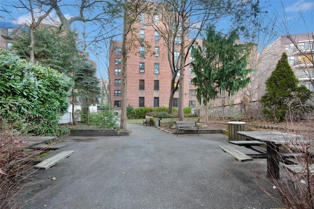 a view of a patio with table and chairs and potted plants