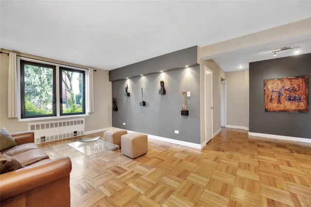 a view of a livingroom with a dinning area hardwood and a kitchen