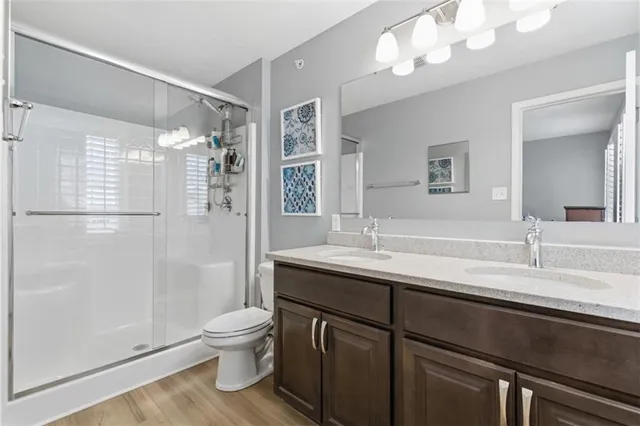 a bathroom with a sink a toilet and shower