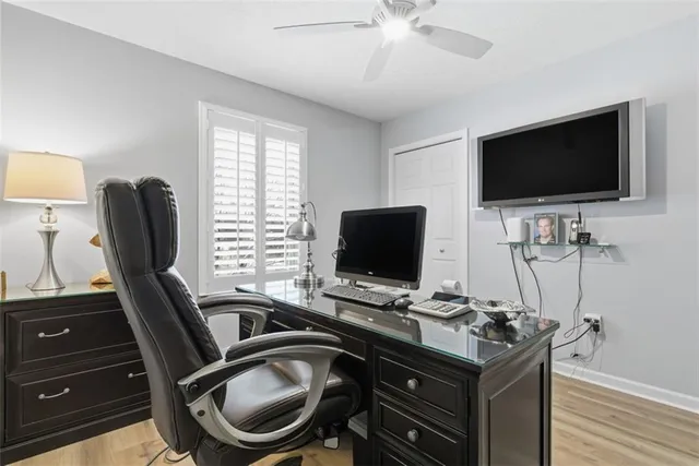 a view of a workspace with furniture and a flat screen tv