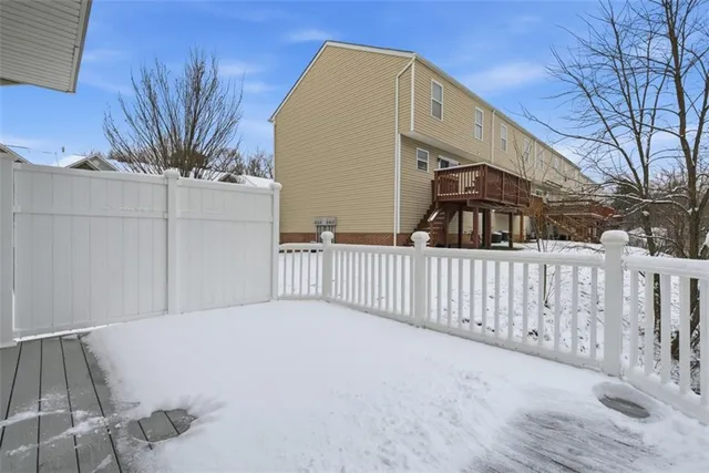 a view of a house with a wooden fence