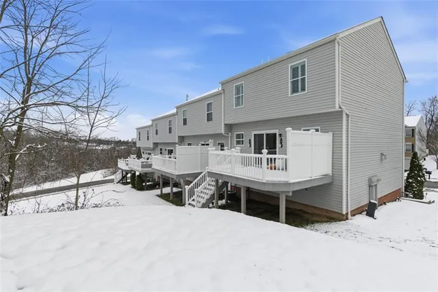 a view of a house with snow on the road
