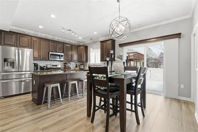 a view of a dining room with furniture large window and wooden floor