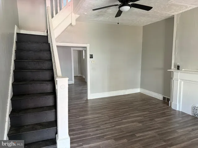 a view of a room with wooden floor
