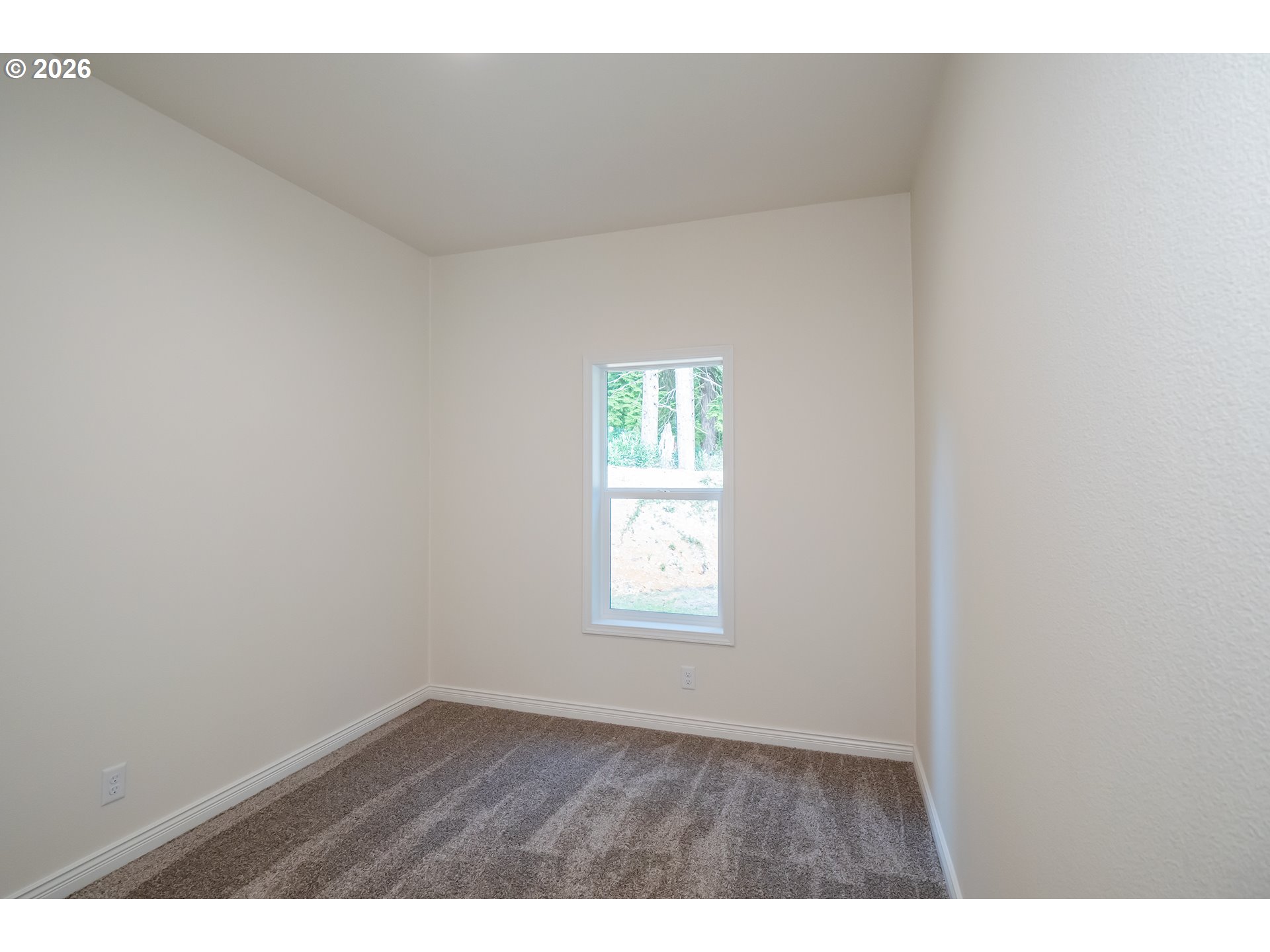 42276 Winberry Creek Road Fall Creek, OR 97438 - Photo 19 of 30 a view of an empty room with wooden floor and a window