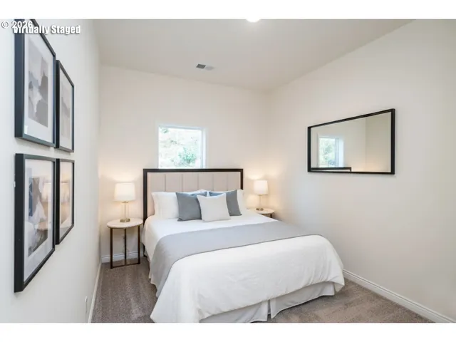 a bedroom with a bed and a large mirror