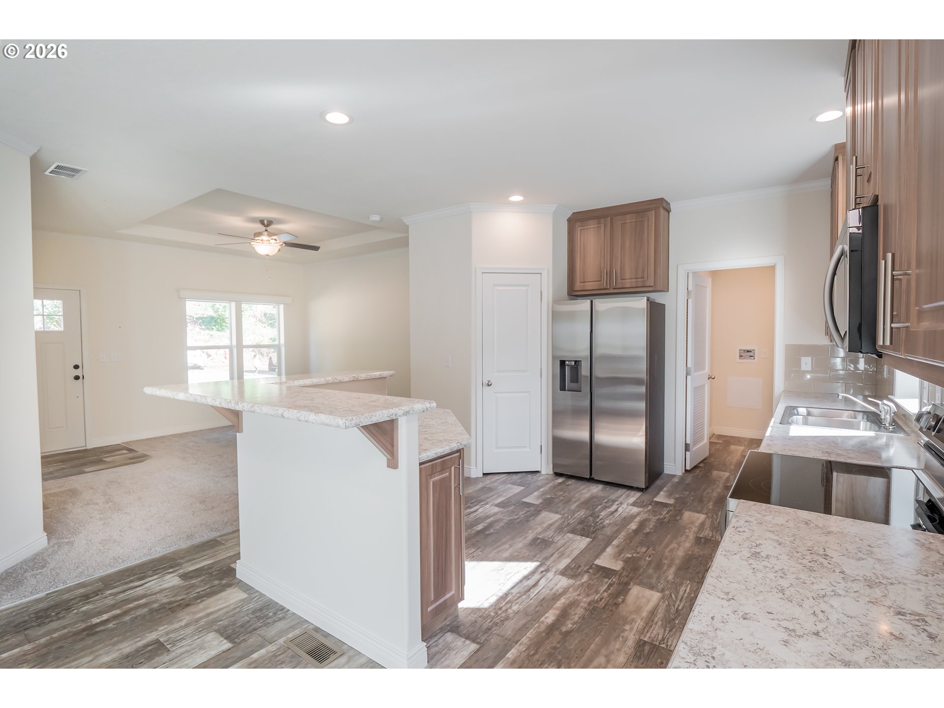 42276 Winberry Creek Road Fall Creek, OR 97438 - Photo 6 of 30 a kitchen with stainless steel appliances kitchen island granite countertop a refrigerator and a sink