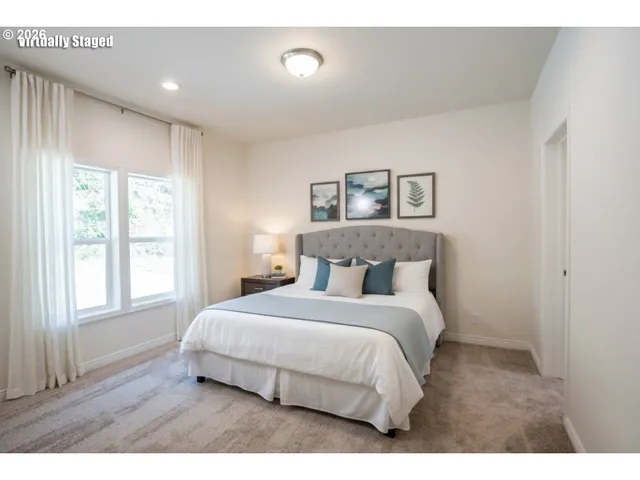 a bedroom with a large bed and a window