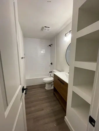 a bathroom with a toilet sink and mirror