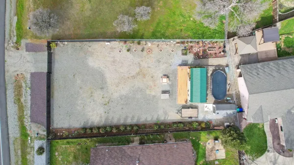 an aerial view of a house with a yard