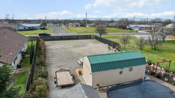 an aerial view of a house with a garden and lake view