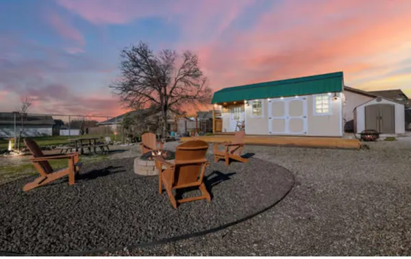 a view of a backyard with sitting area