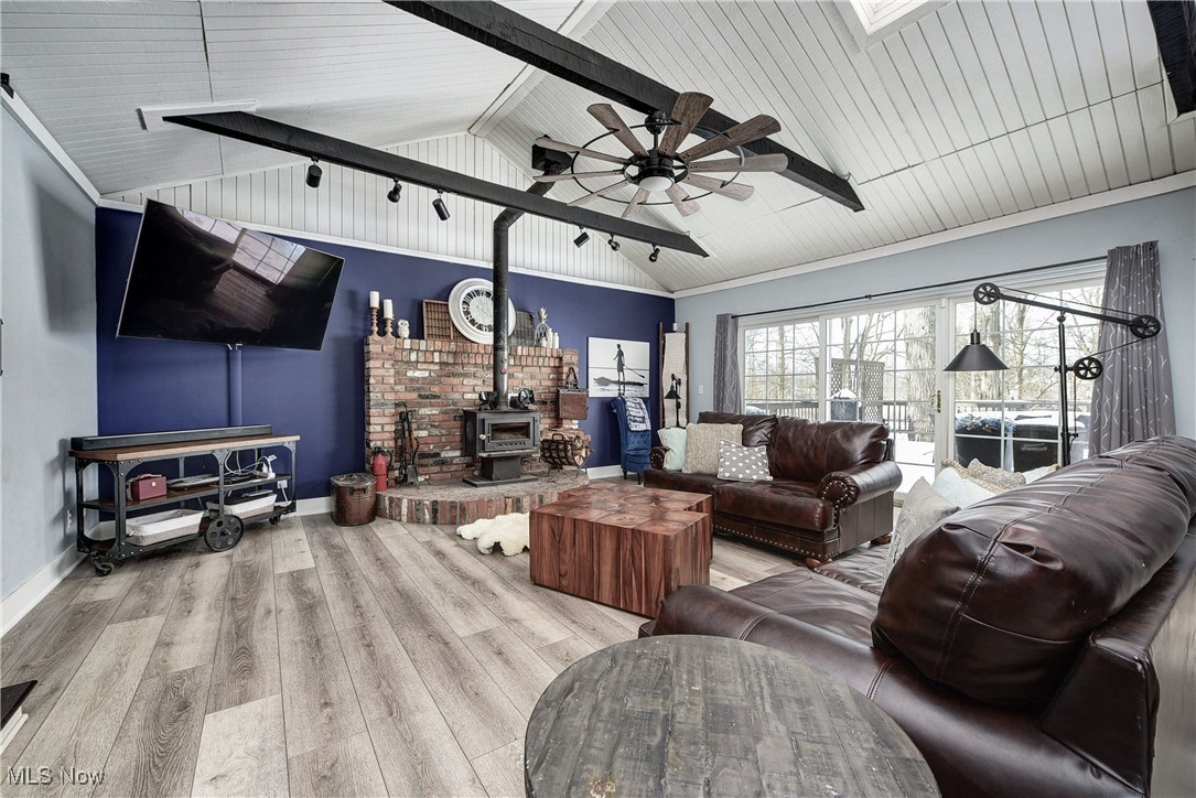 5927 Highland Road Highland Heights, OH 44143 - Photo 13 of 22 Living room with a wood stove, ceiling fan, light hardwood / wood-style floors, lofted ceiling, and wood ceiling
