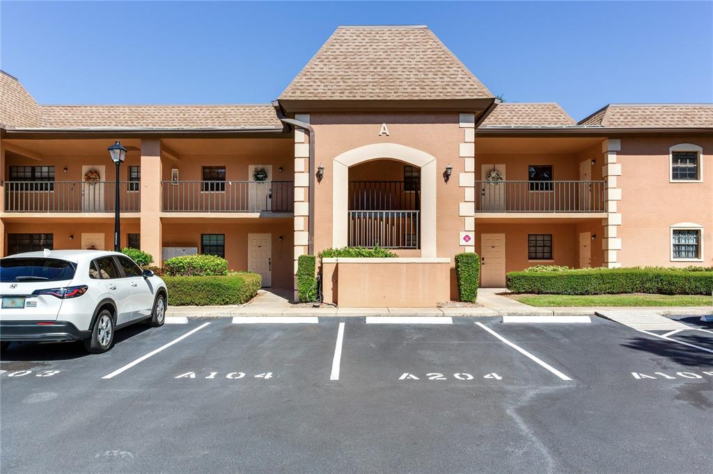 a view of a white house with a large windows next to a road