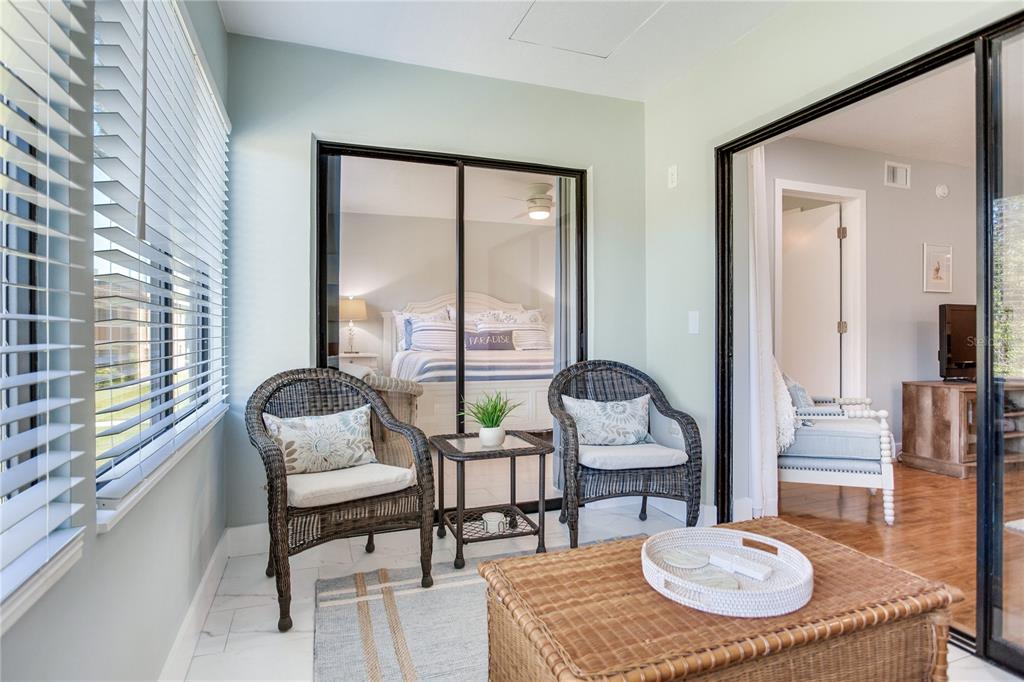 12900 Vonn Road, Unit A204 Largo, FL 33774 - Photo 13 of 40 a living room with furniture and a floor to ceiling window