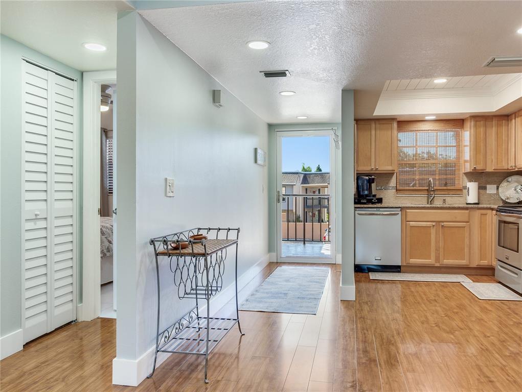 12900 Vonn Road, Unit A204 Largo, FL 33774 - Photo 18 of 40 a kitchen with stainless steel appliances granite countertop a stove a sink and a refrigerator