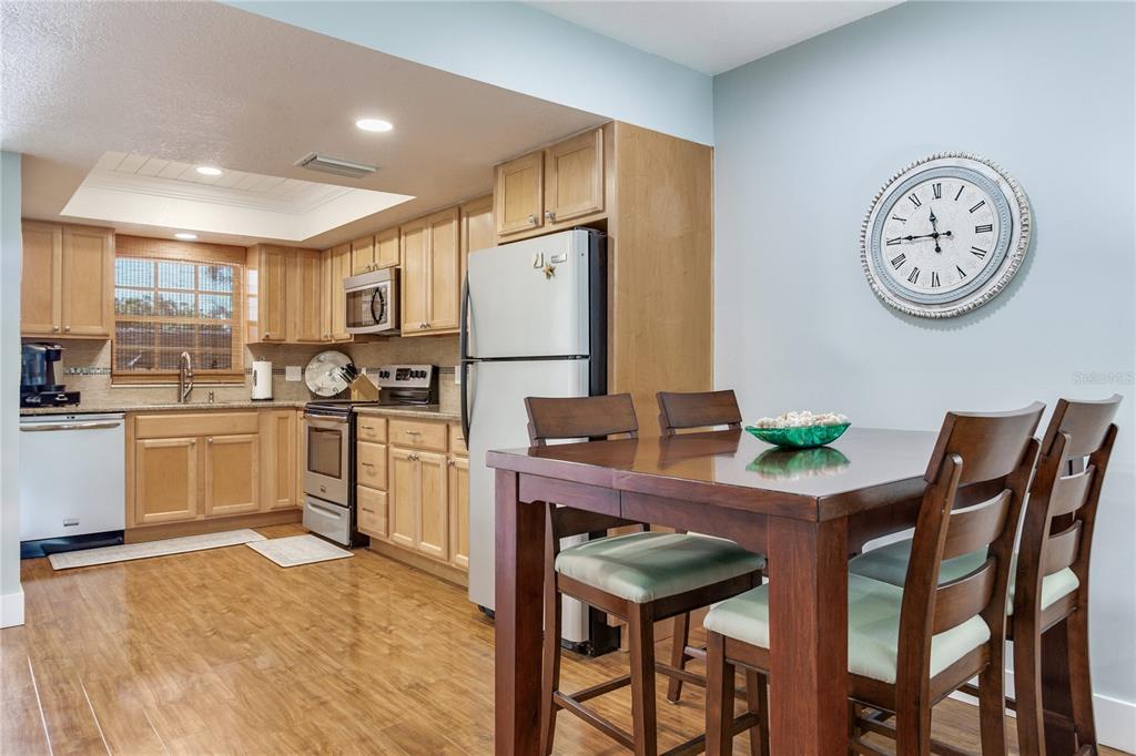 12900 Vonn Road, Unit A204 Largo, FL 33774 - Photo 24 of 40 a kitchen with a dining table and chairs