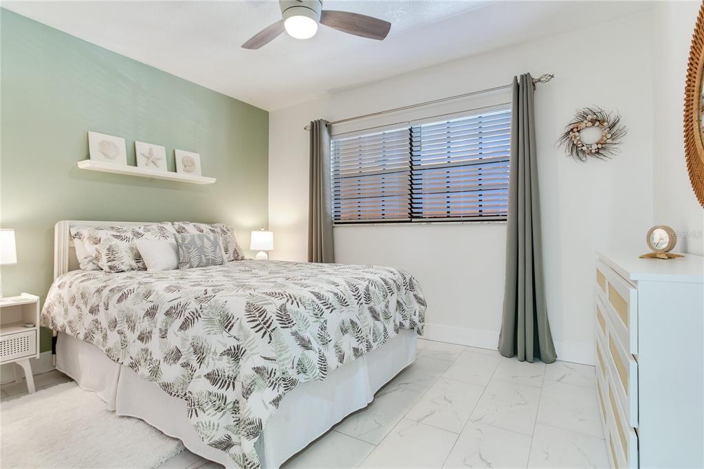 12900 Vonn Road, Unit A204 Largo, FL 33774 - Photo 27 of 40 a bedroom with a bed and a chandelier