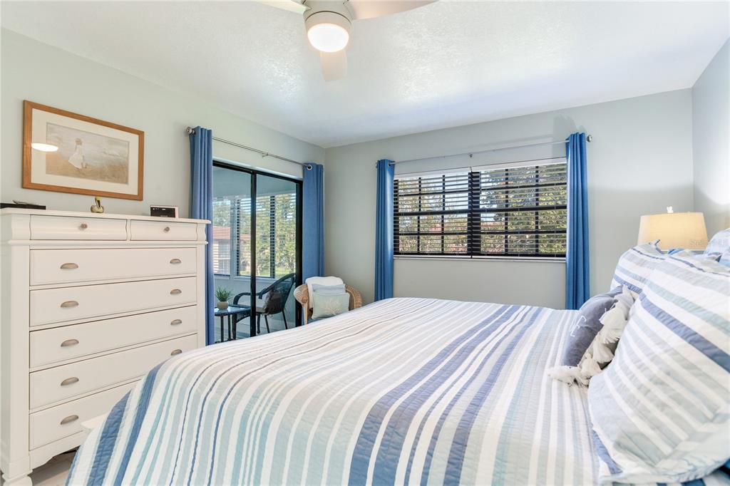 12900 Vonn Road, Unit A204 Largo, FL 33774 - Photo 31 of 40 a bedroom with a bed and a dresser