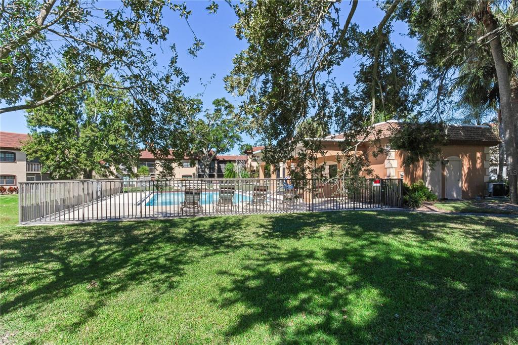 12900 Vonn Road, Unit A204 Largo, FL 33774 - Photo 37 of 40 a view of backyard with swimming pool and green space