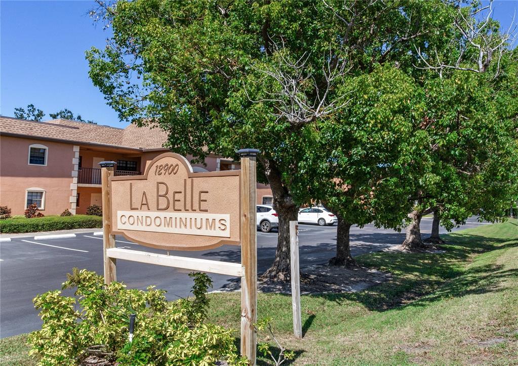 12900 Vonn Road, Unit A204 Largo, FL 33774 - Photo 39 of 40 a view of a street sign under a large tree