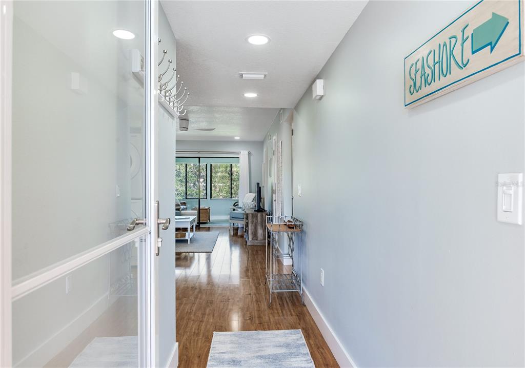 12900 Vonn Road, Unit A204 Largo, FL 33774 - Photo 5 of 40 a hallway with a large window and couch