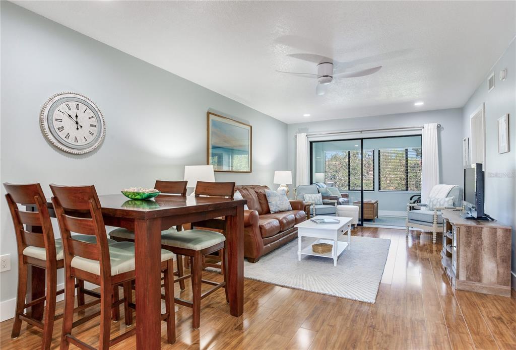 12900 Vonn Road, Unit A204 Largo, FL 33774 - Photo 6 of 40 a living room with furniture and wooden floor