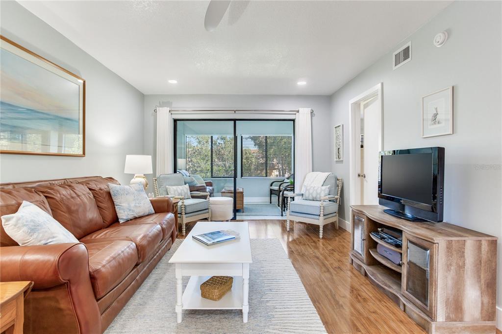 12900 Vonn Road, Unit A204 Largo, FL 33774 - Photo 7 of 40 a living room with furniture and a flat screen tv