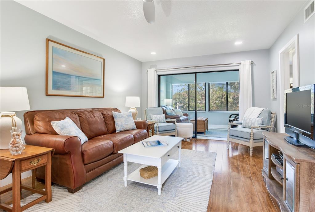 12900 Vonn Road, Unit A204 Largo, FL 33774 - Photo 8 of 40 a living room with furniture and a flat screen tv