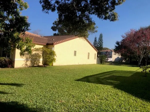a view of a big yard with a house