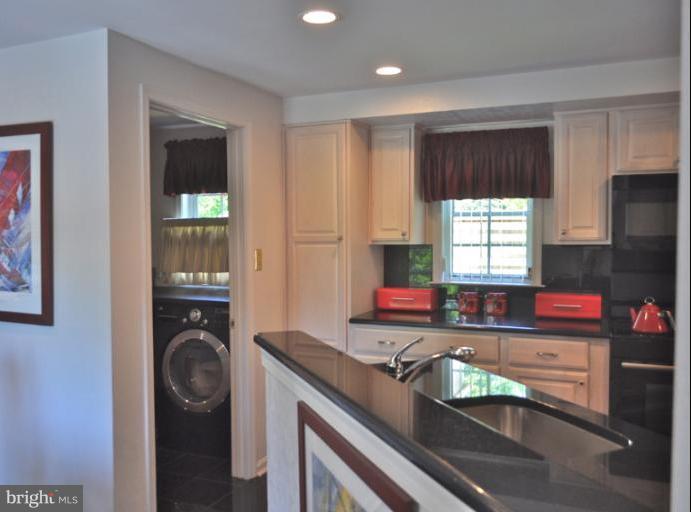 1550 Deer Point Way Reston, VA 20194 - Photo 18 of 30 a kitchen with stainless steel appliances granite countertop a stove and a sink
