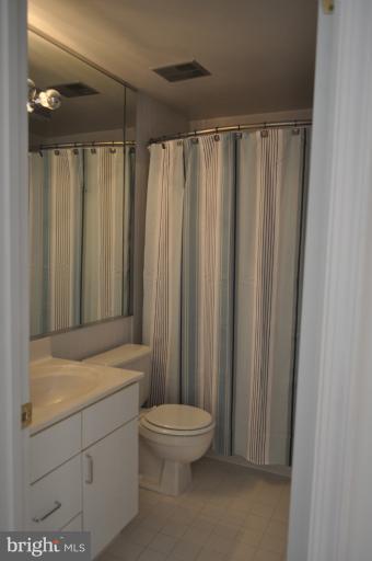1550 Deer Point Way Reston, VA 20194 - Photo 22 of 30 a bathroom with a shower curtain and a sink