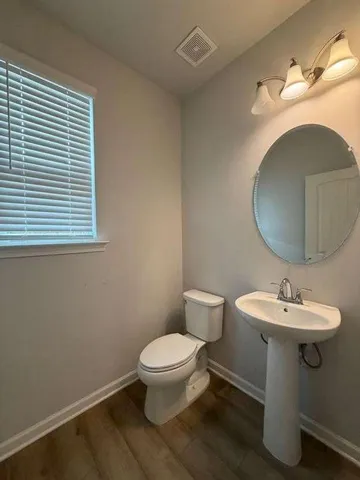 a view of a kitchen with a sink and dishwasher a refrigerator with wooden floor