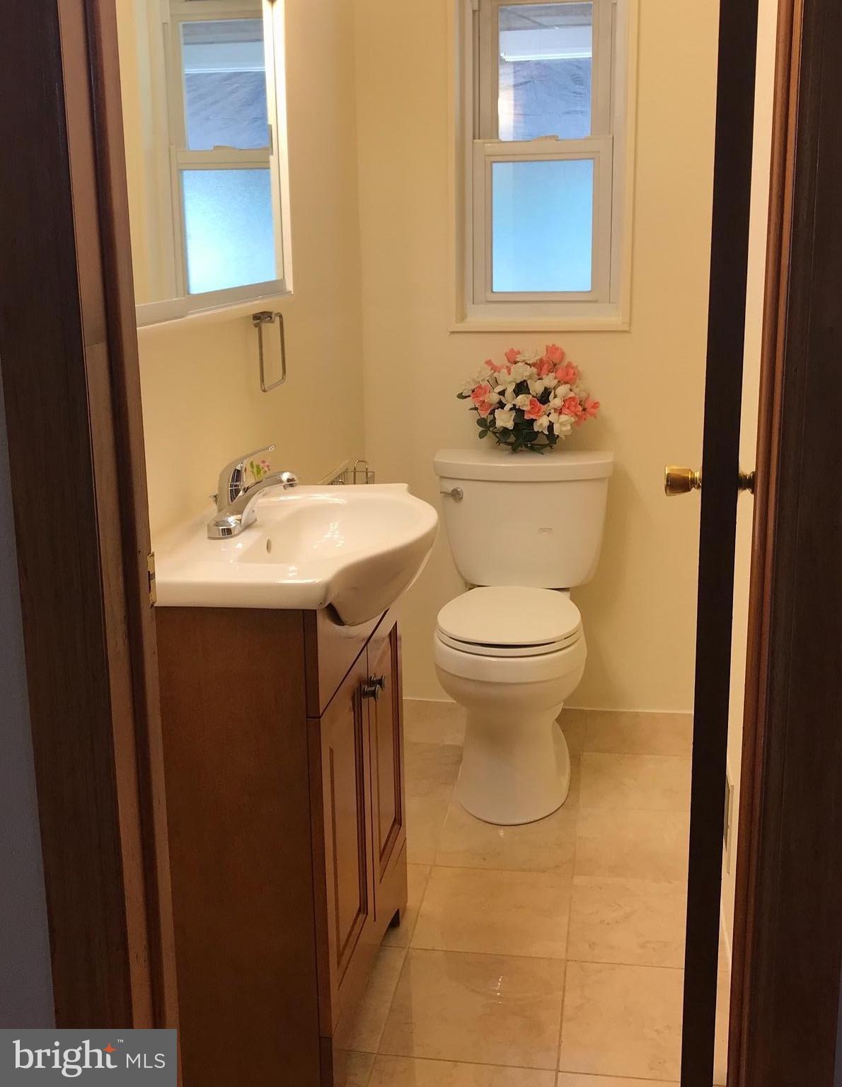 7437 Axton Street Springfield, VA 22151 - Photo 14 of 26 a bathroom with a sink toilet and mirror