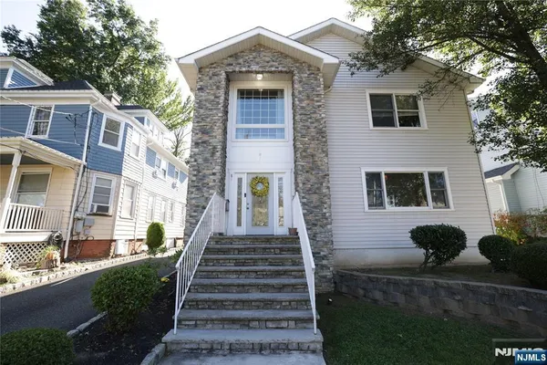 a front view of a house with stairs
