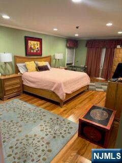 59 Spring Valley Avenue Hackensack, NJ 07601 - Photo 18 of 26 a bedroom with a bed and a dresser with mirror