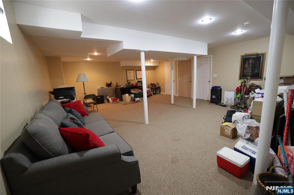 59 Spring Valley Avenue Hackensack, NJ 07601 - Photo 23 of 26 a living room with furniture and a flat screen tv