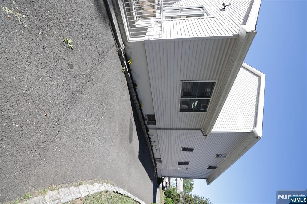 59 Spring Valley Avenue Hackensack, NJ 07601 - Photo 24 of 26 a front view of a house with a yard