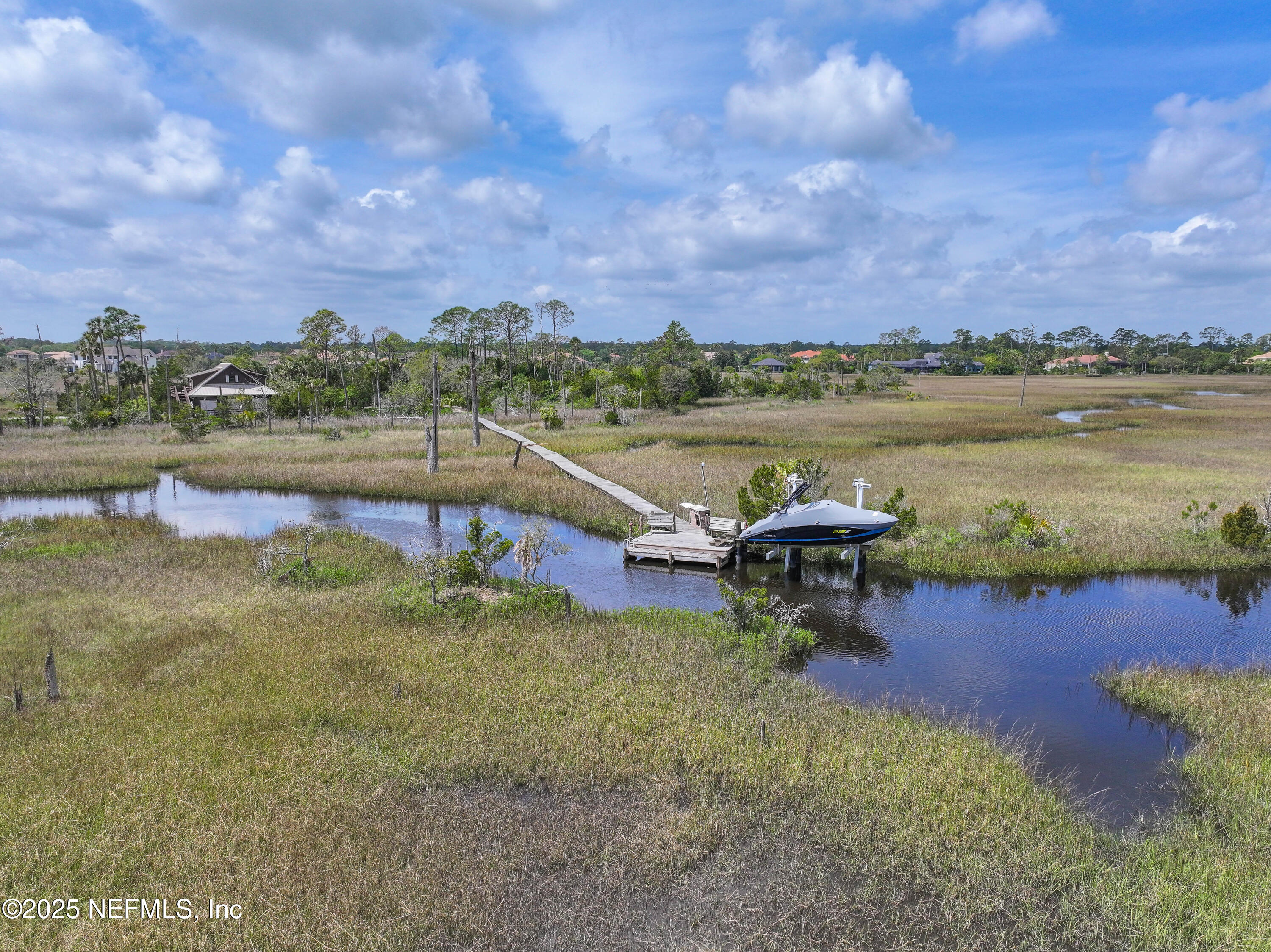 24631 Deer Trace Drive Ponte Vedra Beach, FL 32082 - Photo 22 of 33 a view of a lake with lawn chairs and a table