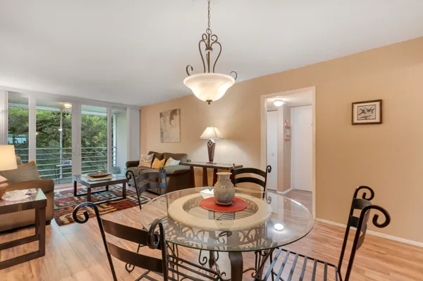 a dining room with furniture and wooden floor