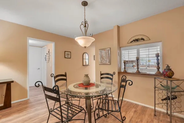 a view of a dining room with furniture and chandelier