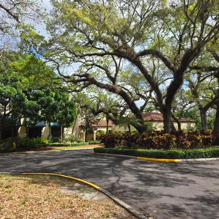a living room with lots of furniture and a large window