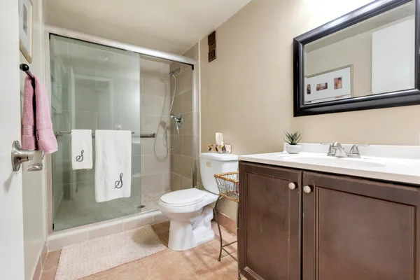 a spacious bathroom with a sink toilet and shower