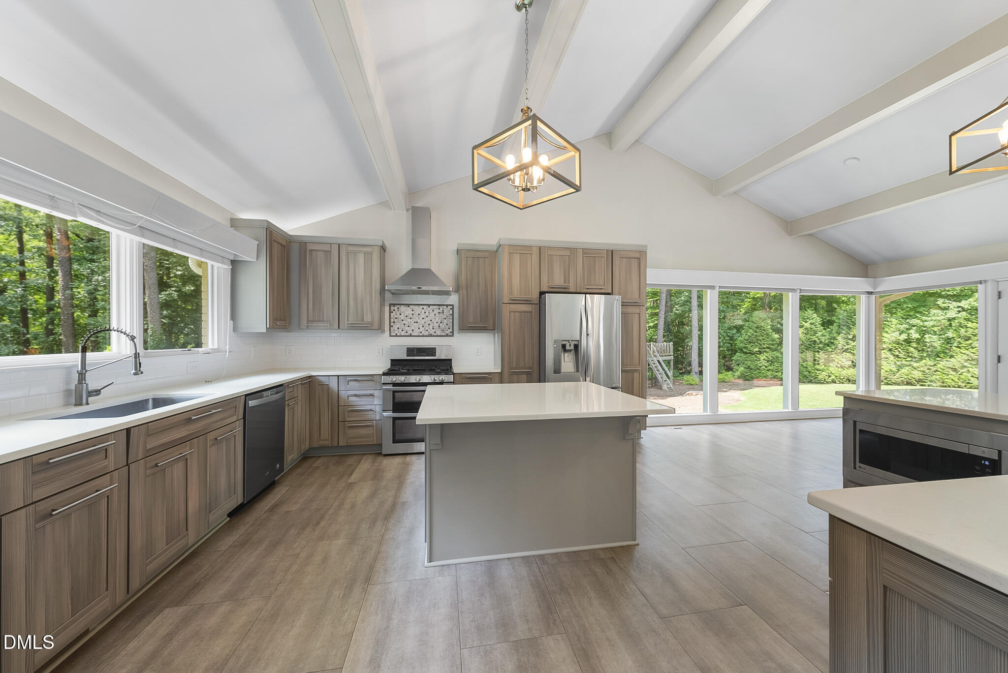 1605 Ridge Road Raleigh, NC 27607 - Photo 12 of 34 a large kitchen with stainless steel appliances a large window a oven a stove and a refrigerator