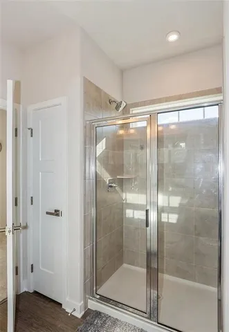 a bathroom with a glass shower door