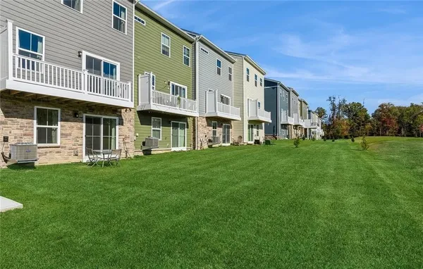 a front view of a building with a garden